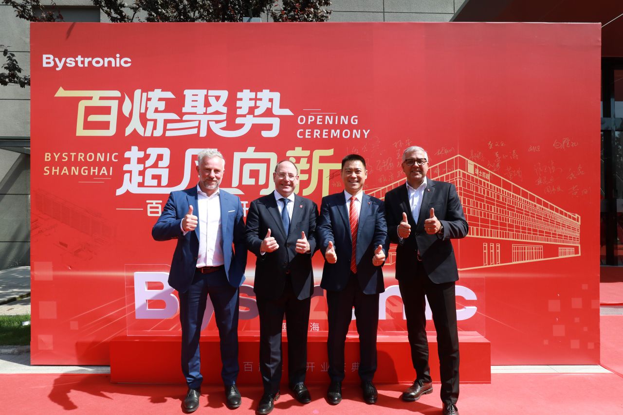 Bystronic leaders in front of the opening sign for Bystronic China