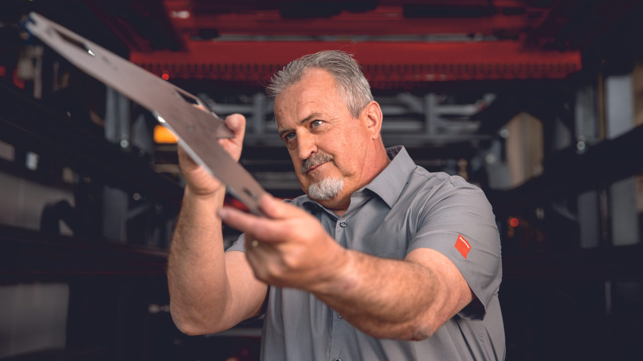Man looking at a metal sheet