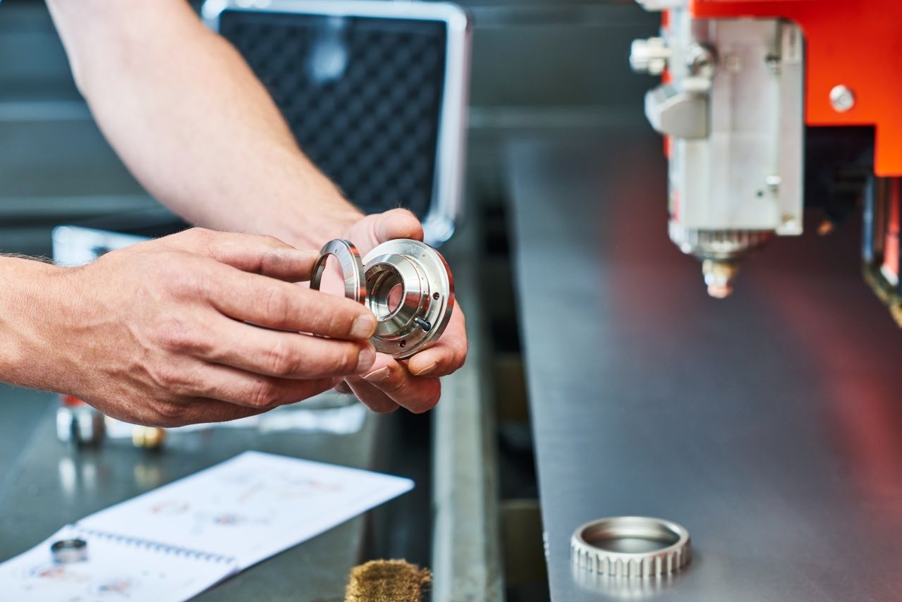 Hands disassemble the consumable part of a machine