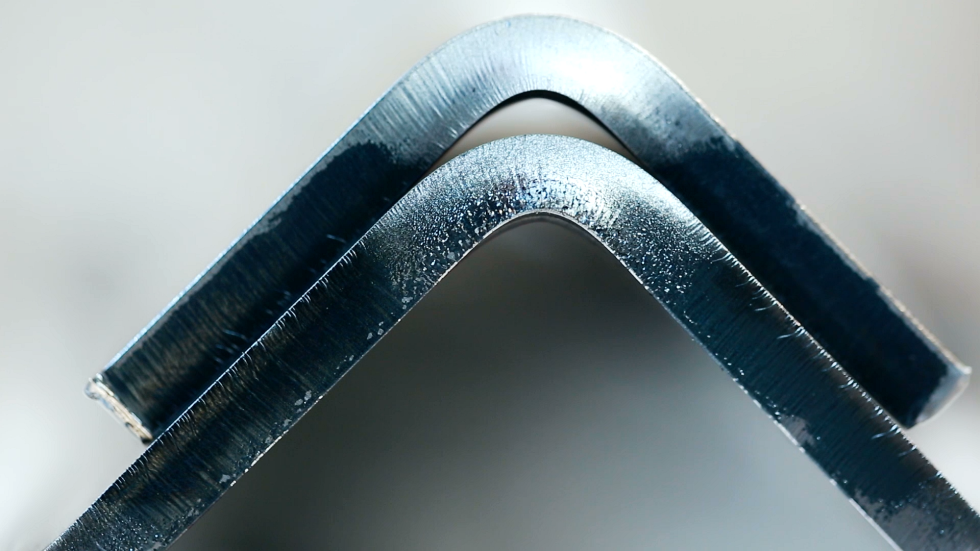 An image showing a hydraulic bending machine in operation, efficiently bending metal sheets with a heavy-duty sheet metal bender in a manufacturing environment.