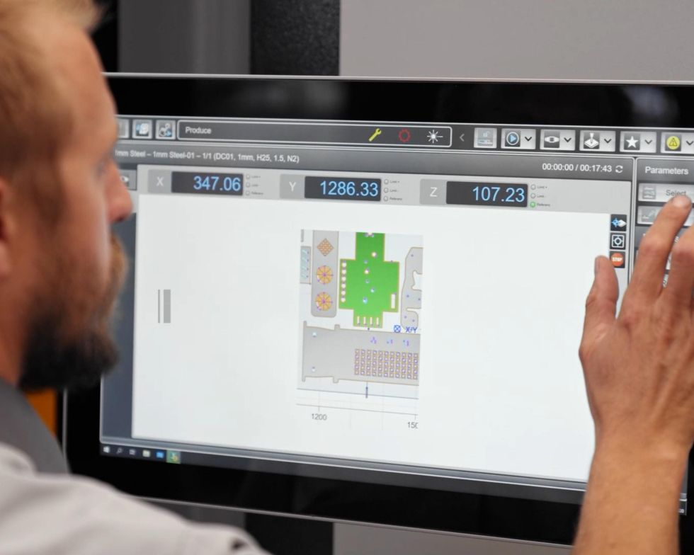 Man controls fiber laser machine on a touch screen