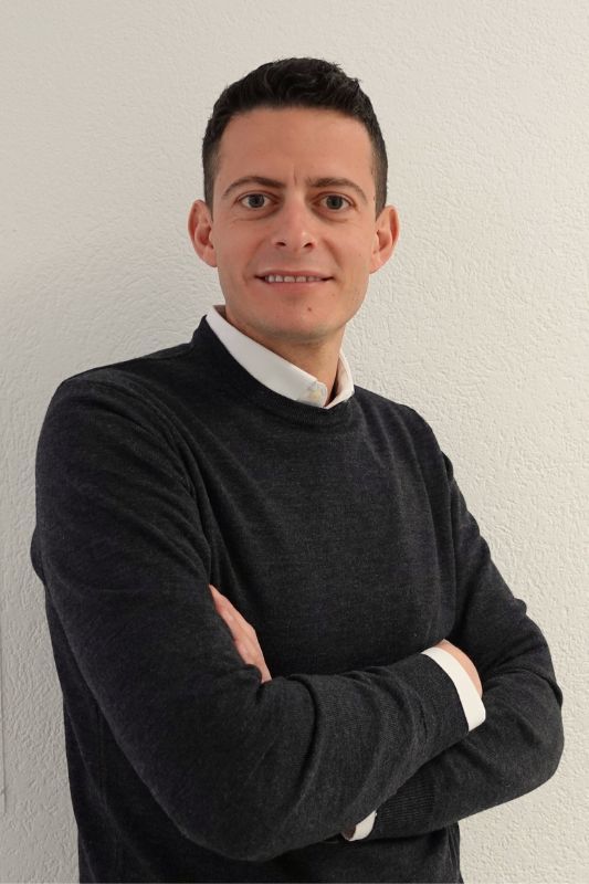 smiling man with short dark hair 