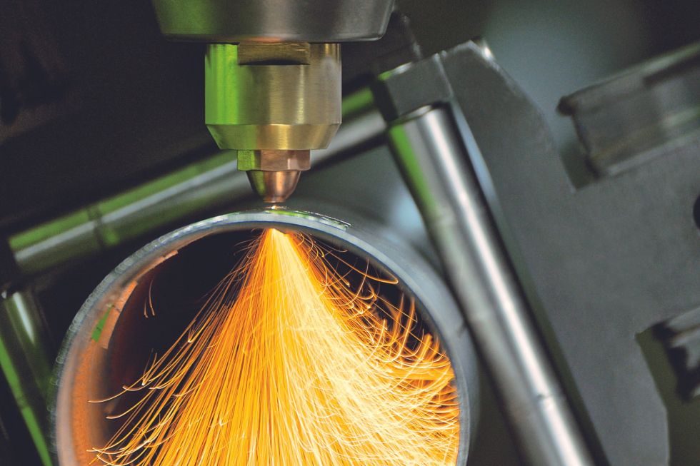 close up of a tube laser cutter, cutting a round profile