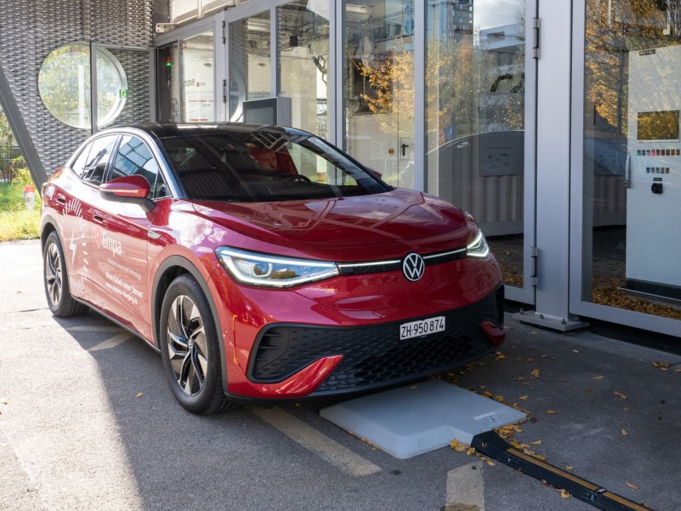 An electric car being charged without cable