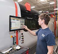 Operator Zach Gorvett checks on cutting parameters on the Bystronic ByStar Fiber laser cutting machine.