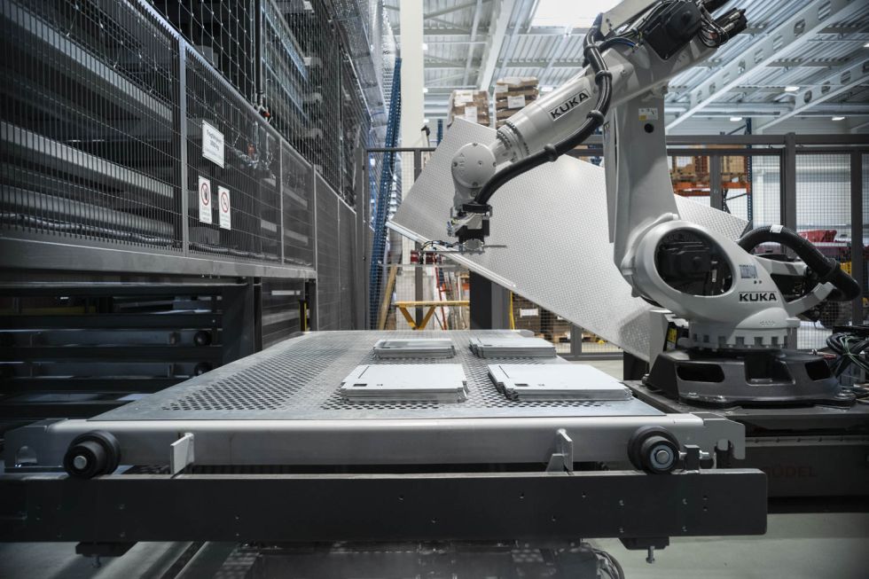 The Kuka robot autonomously retrieves the metal sheets from the high-bay warehouse.