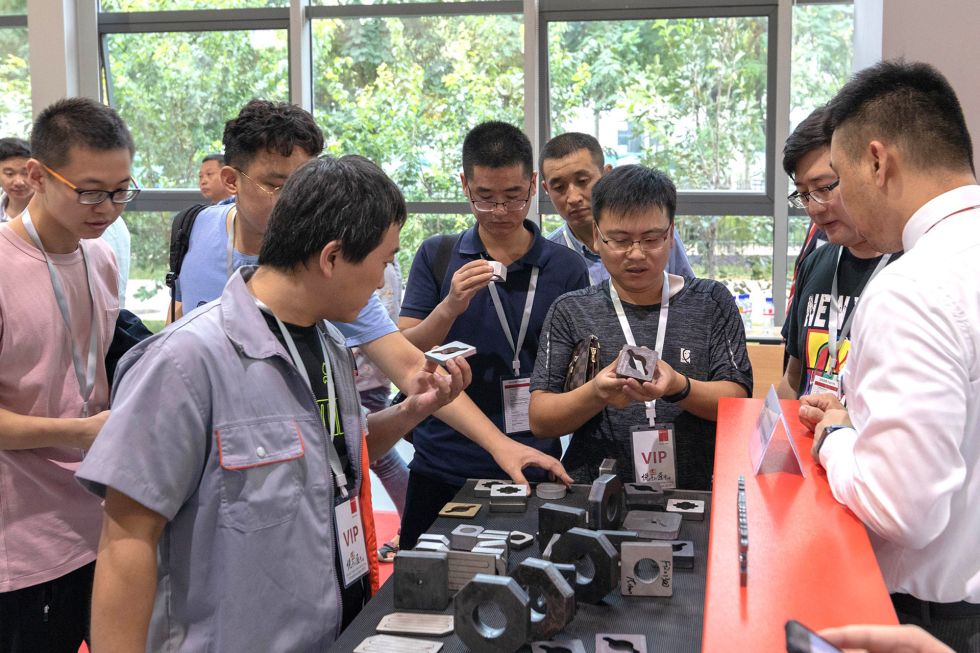 Customers inspect finished laser-cut parts.