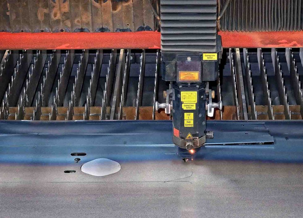 The two Bystronic press brakes being used in tandem to fold a large sheet metal panel.