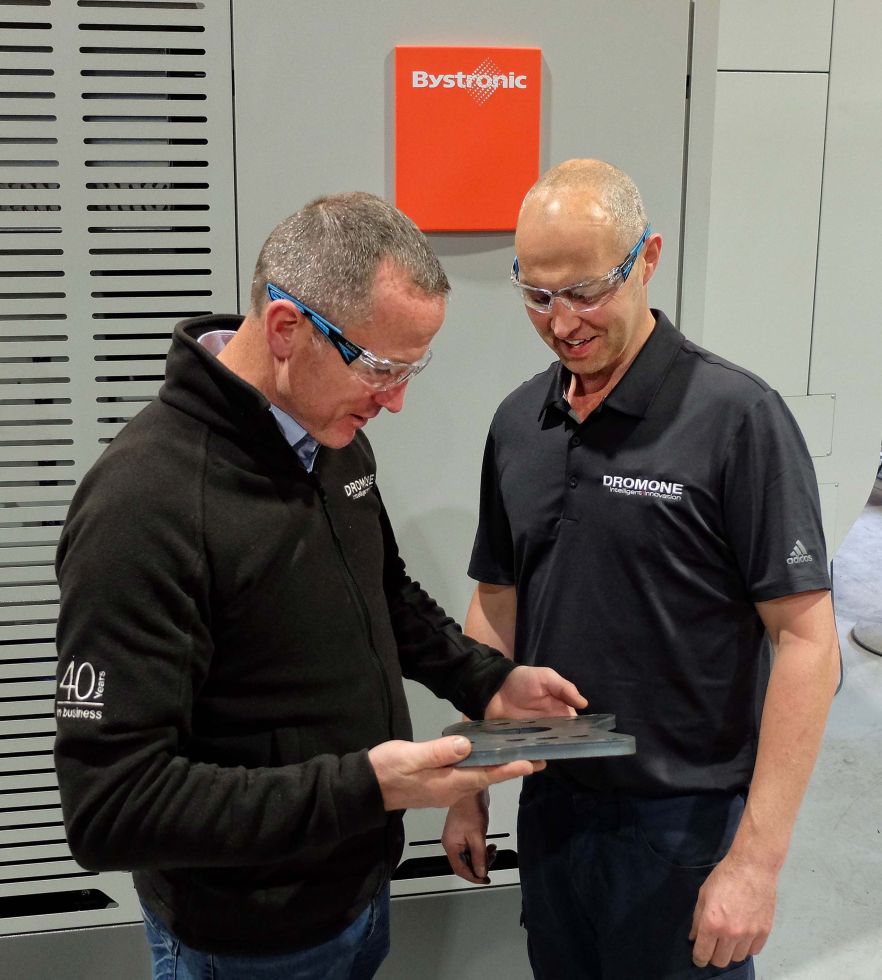 Ollie Devine (left) and David Gray inspecting one of the  laser-profiled, 12 mm mild steel tractor hitch parts.