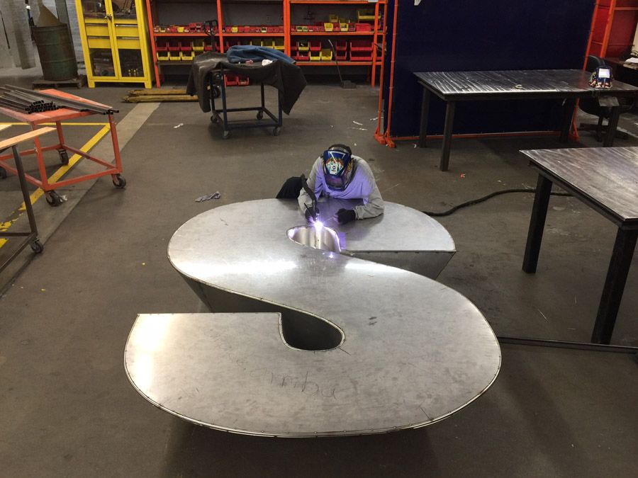 Display work involves multiple materials in the same finished piece. Fortunately, a CO2 laser makes short work of cutting wood, as well as metal.